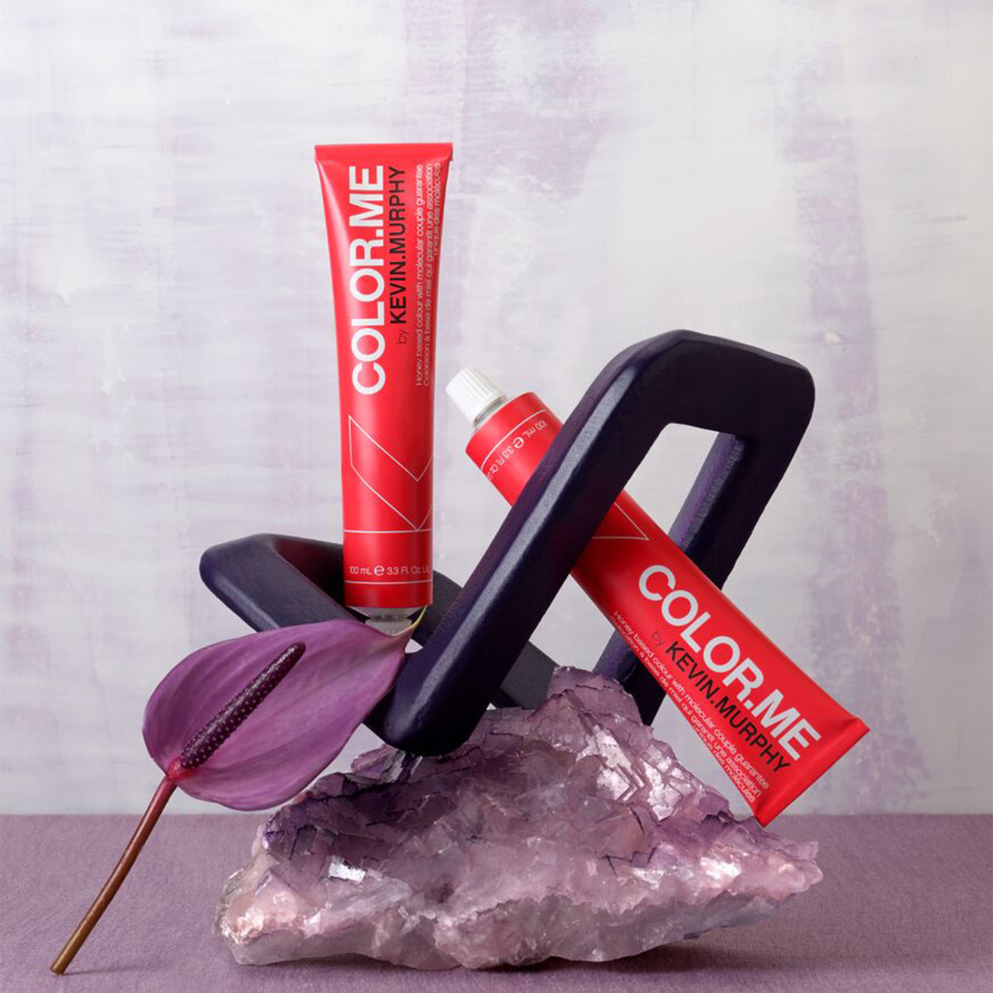 Red hair color tubes with salon chair and purple flower on amethyst base